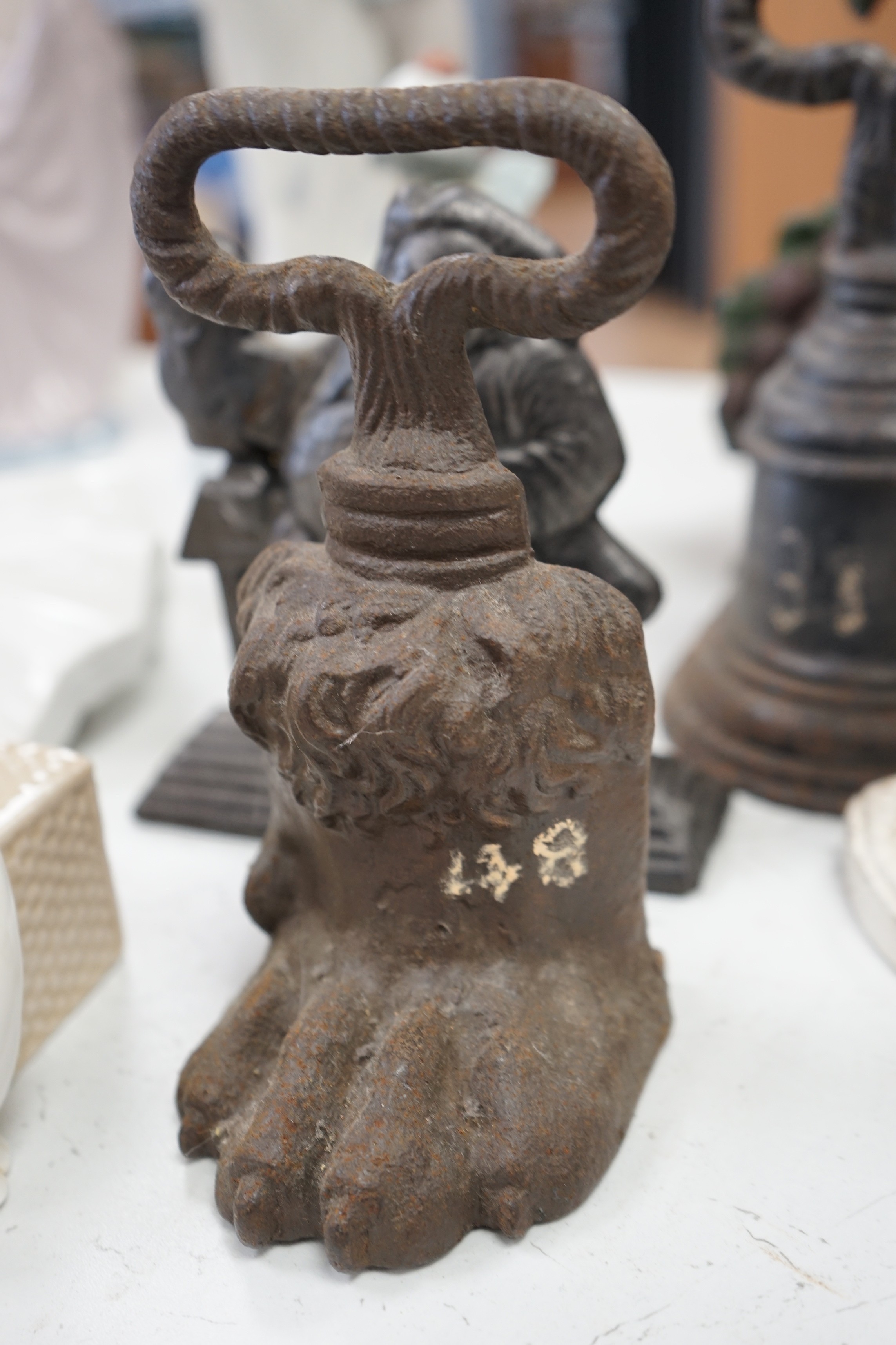 Six assorted Victorian cast iron door stops, some later painted, 27cm tall